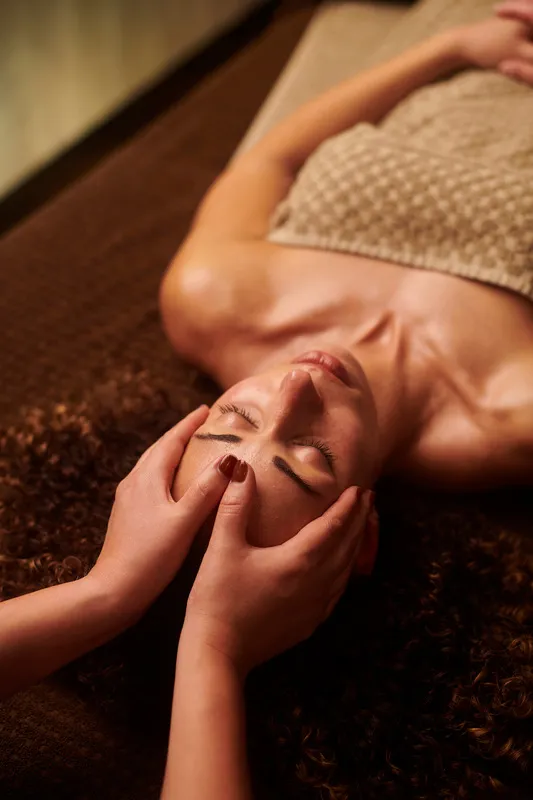 A client relaxing during a scalp massage